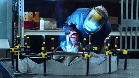 Welder-in-protective-uniform-conducting-welding-of-aircraft-engine-part