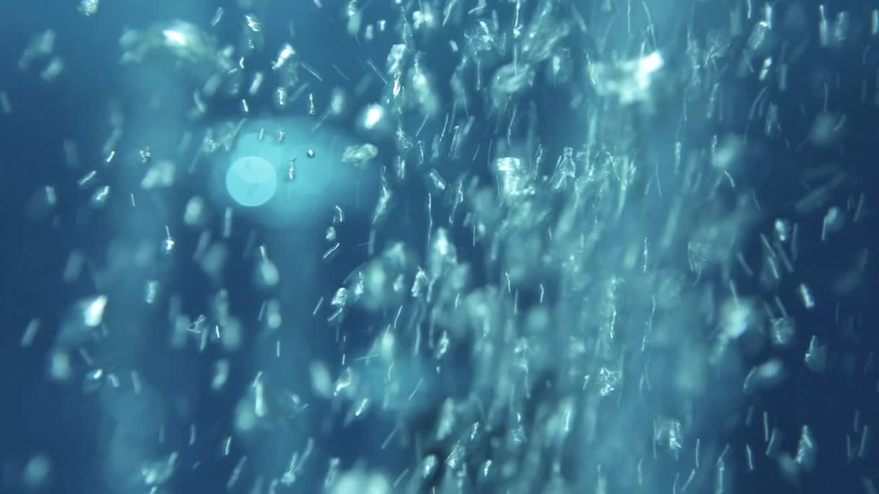 Bubbles Close up crossing the frame in deep olympic swimming pool