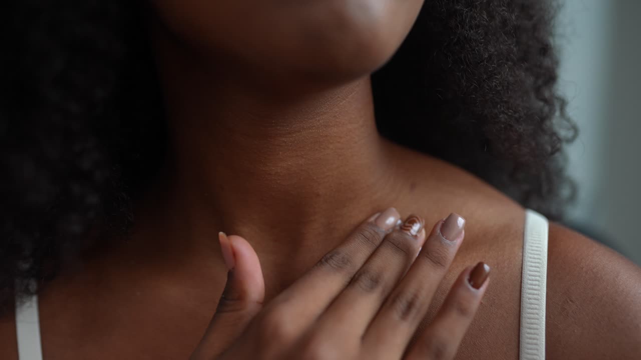 Donna che applica la crema su collo e petto