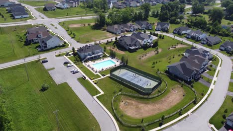 People-out-in-suburban-home-community-playing-tennis-on-the-tennis-court