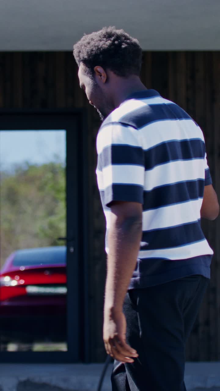 Man Charging Electric Vehicle