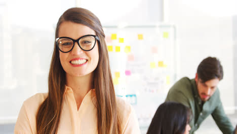 Smiling-executive-standing-with-arms-crossed