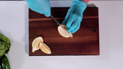 Slow-motion-overhead-shot-of-lemon-being-sliced