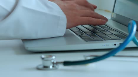 the fanendoscope in the foreground, the hands of a man of a man print the text on the keyboard, a medical examination, a selective focus