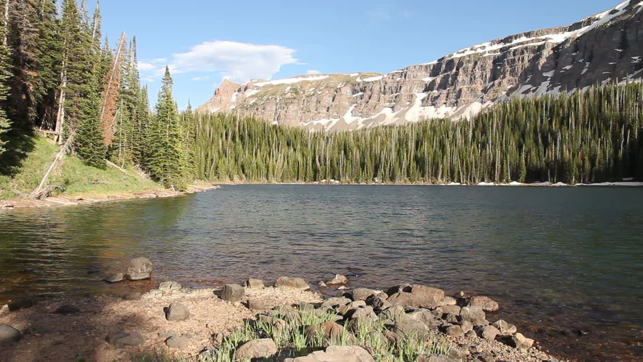 Remote Deep Lake located below the Chinese Wall cliffs in the Flat Tops Wilderness Area, Colorado, USA.
