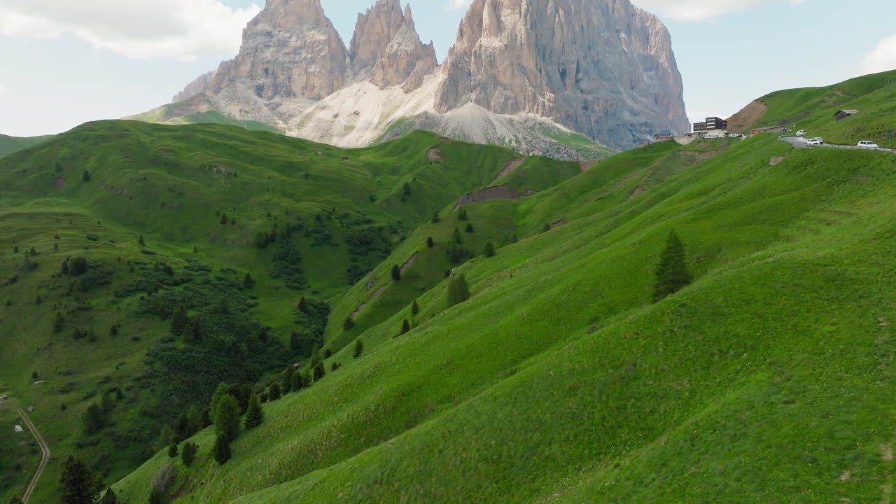 Slow drone reveal shot of Sassolungo mountain in Dolomites, Italy