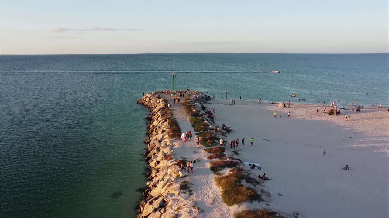 following fishing boat with drone over family beach and coast line in las dunas chuburna yucatan peninsula mexico