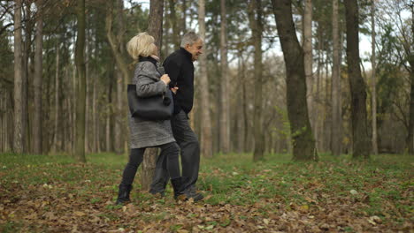 elderly couple walking in forest