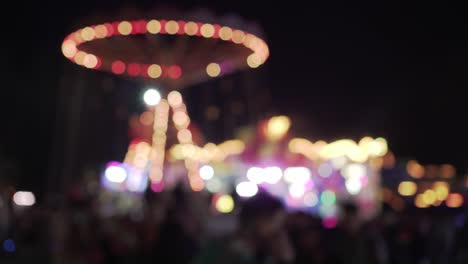 blurry lights of chain carousel during carnival fair