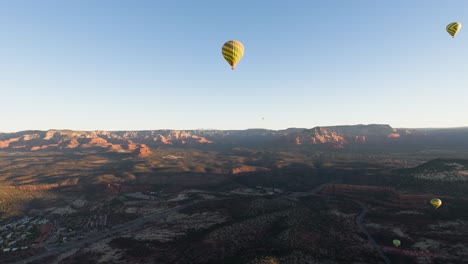 Hot-air-balloon-ride-POV,-multiple-yellow-balloons-in-air