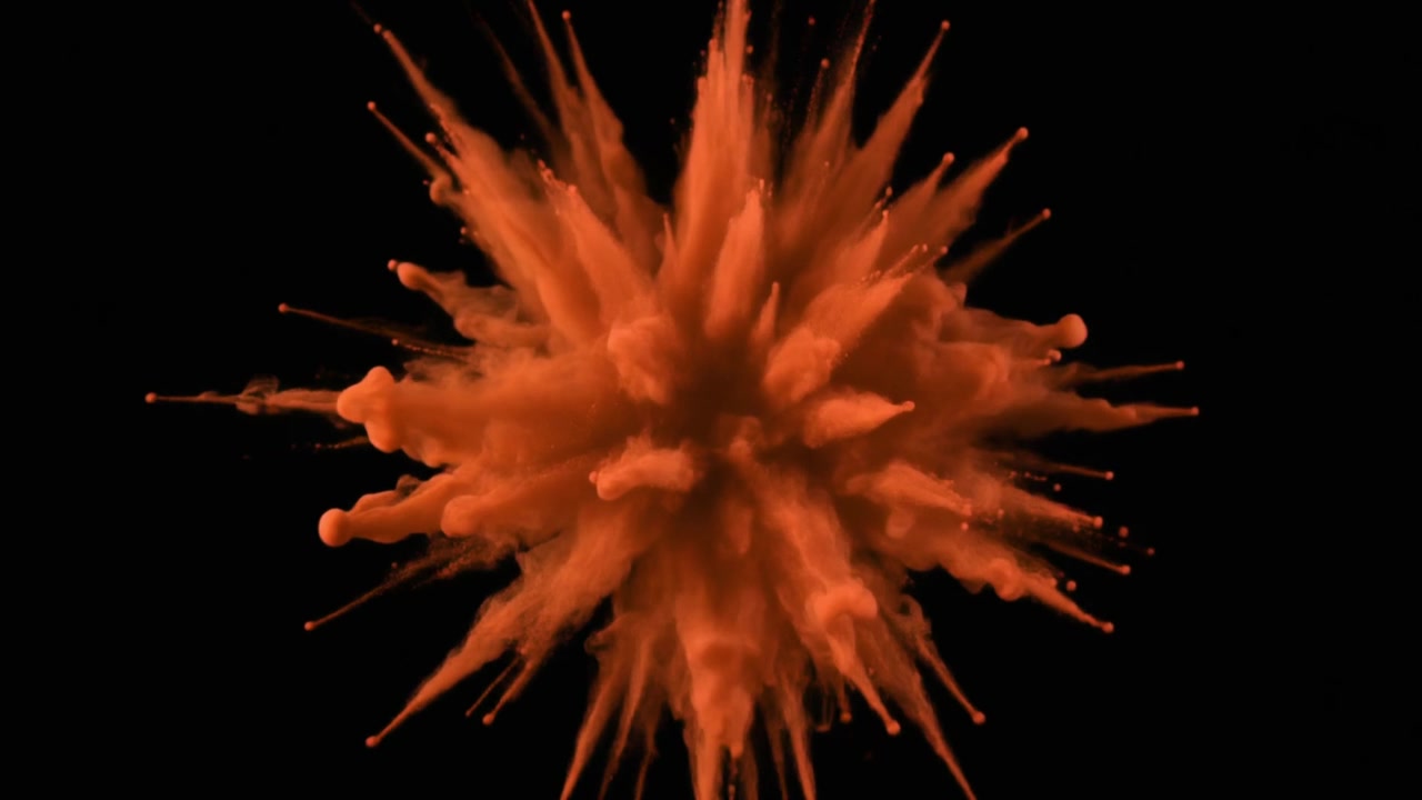Orange Powder Explosion Isolated on Black Background