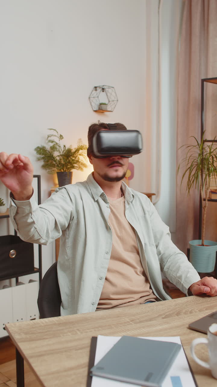 Confident young caucasian man freelancer using vr headset while sitting at home office table desk