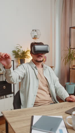 confident young caucasian man freelancer using vr headset while sitting at home office table desk