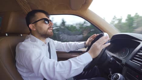 businessman is driving a car.