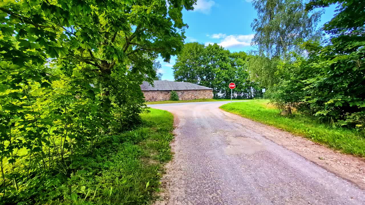 Quiet Countryside Road With Stop Sign And Trees On Summer Day