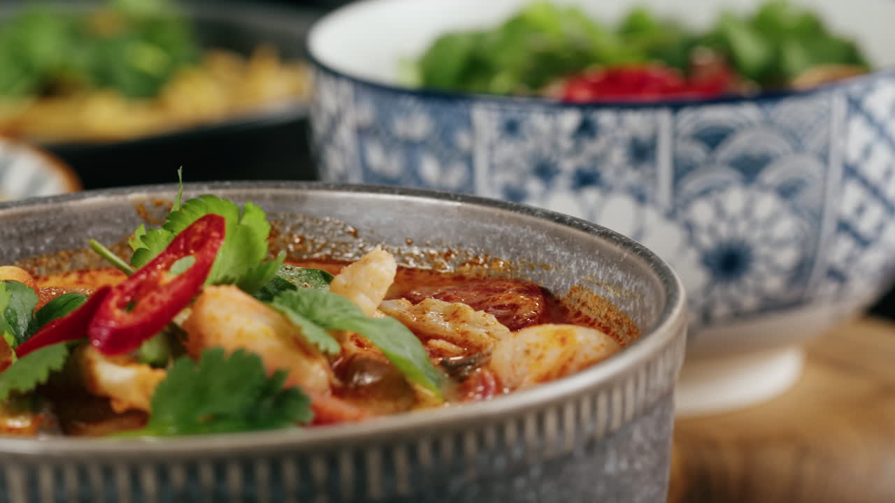 Bowl of soup with cilantro and chili pepper