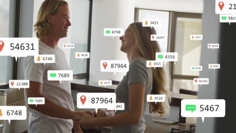 Animación-De-Notificaciones-De-Redes-Sociales-Sobre-Una-Pareja-Feliz-Bailando-En-Una-Cocina-Soleada