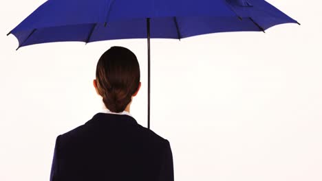 businesswoman standing and holding umbrella