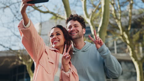 selfie, peace sign and kiss with a couple