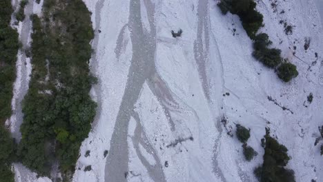 shallow river of dolomites mountain, aerial top down view