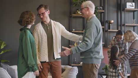 Grandfather-Greeting-His-Relatives-During-A-Family-Reunion-At-Home