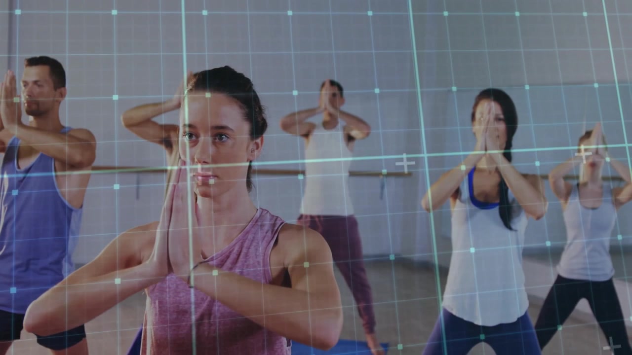 Yoga participants lowering hands into prayer pose on mats as grid overlay sliding tracking posture