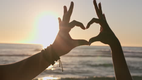 couple, heart and hands at beach in sunset sky