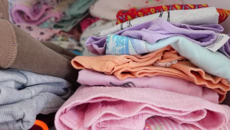 stacked children's clothes in a drawer or wardrobe