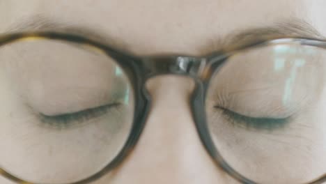 detail of a girl's eyes slowly opening from closed and looking into the room