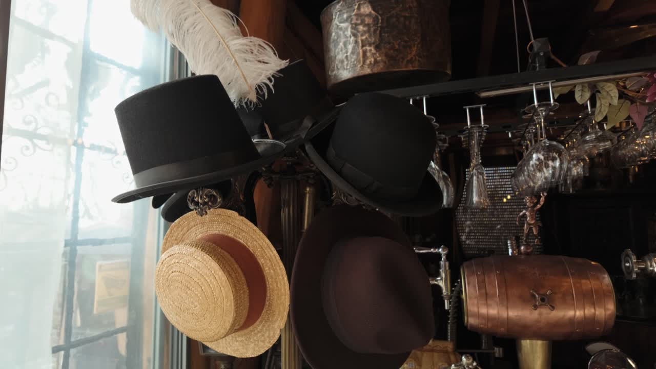 Assorted classic hats hanging inside a cozy vintage room