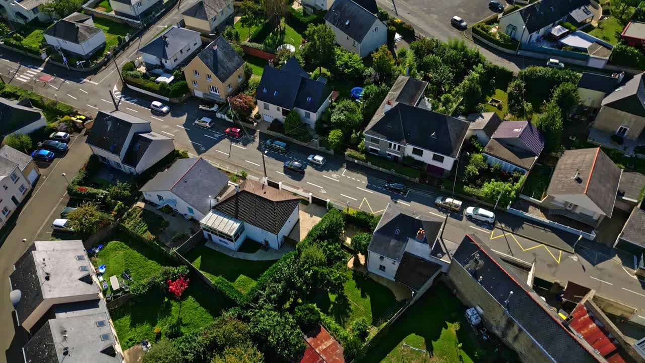 Aerial establishing overview of Laval suburbs with houses, roads, and green spaces in daylight