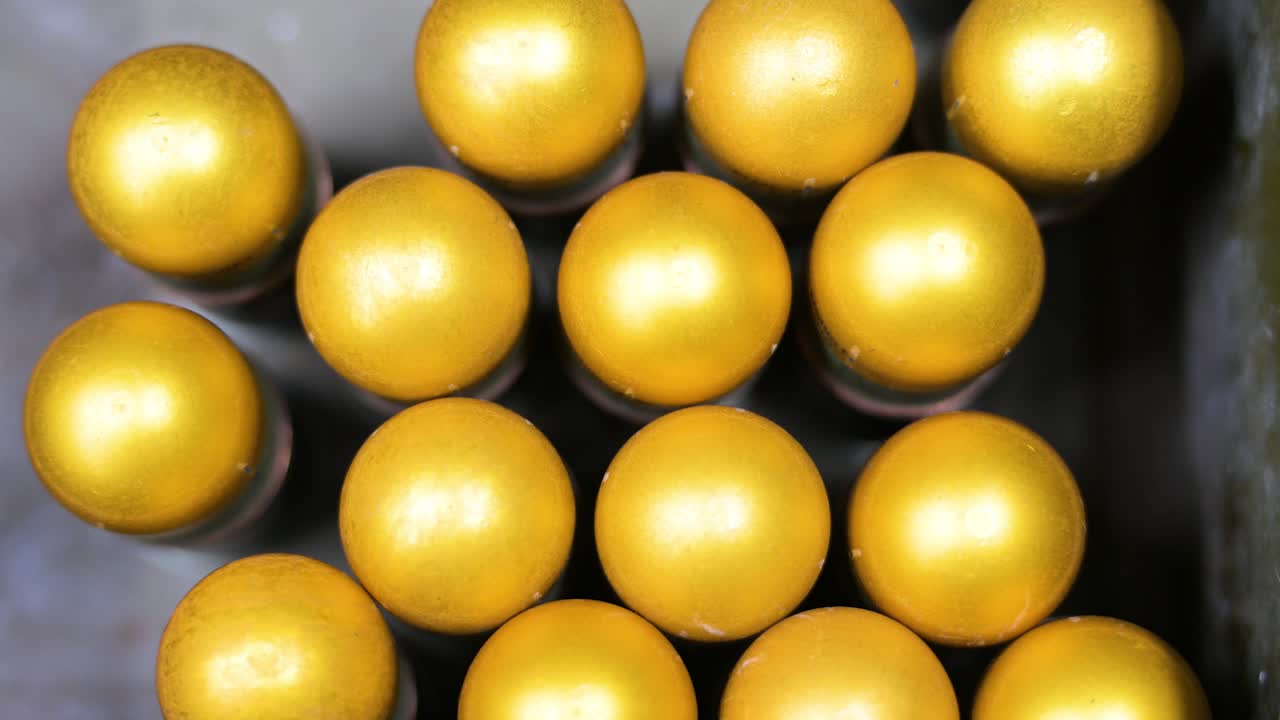 Overhead view: Grenades await modification with plastic casings for drones at a workshop in Ukraine's Donetsk region. Showcasing adaptive weapon tech for modern warfare.