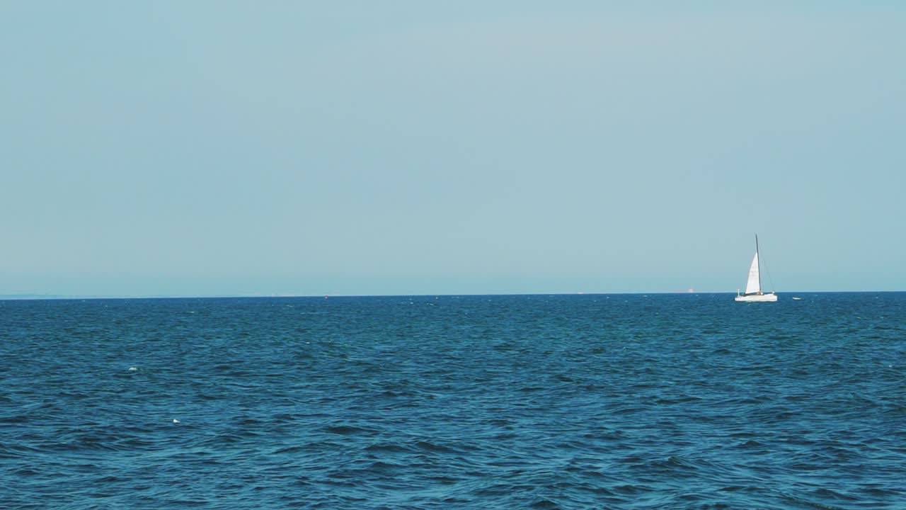 Sea with a sailboat on the horizon. Sea horizon.