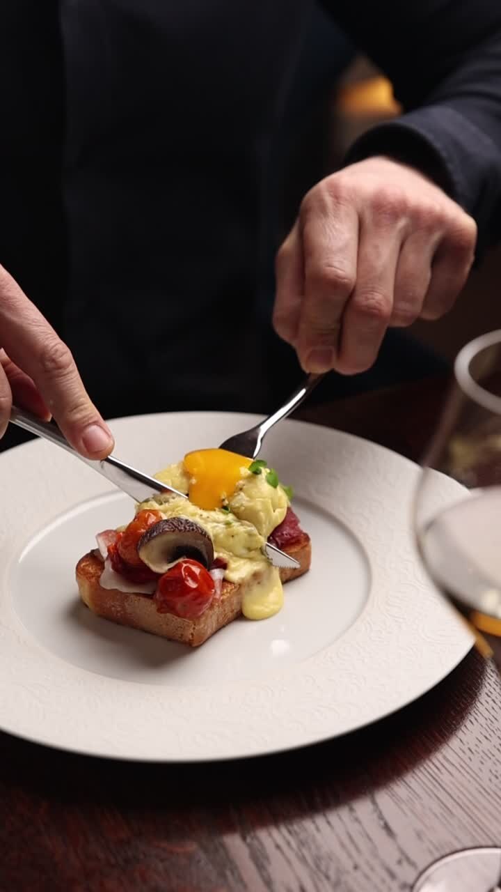 Cutting into a Poached Egg with Runny Yolk on Gourmet Toast
