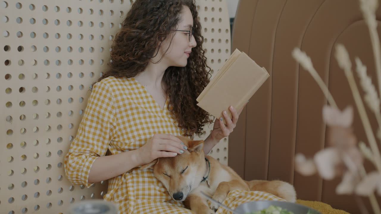 Woman Reading with Dog at Home