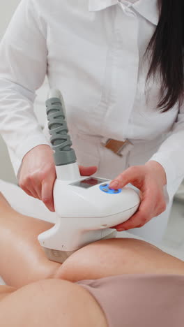 anticellulite massage cosmetologist makes a woman cavitation vacuum rf lifting spa legs procedure