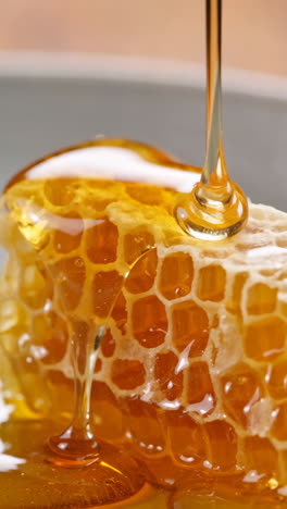 golden honey pouring over fresh honeycomb