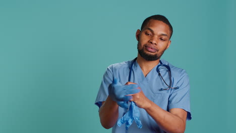 Male-nurse-putting-on-rubber-gloves,-preparing-for-surgery