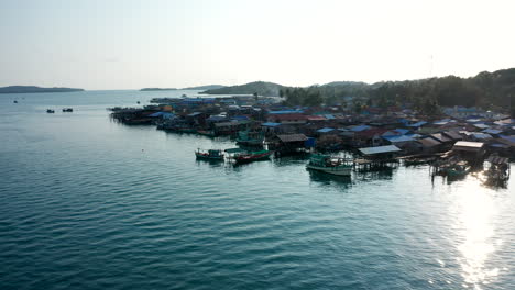 aerial drone footage moving forward over a fisherman floating village in king island, cambodia