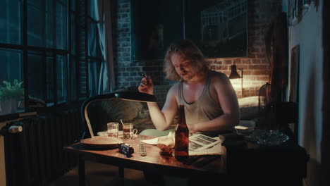 man working late at night in a cozy apartment