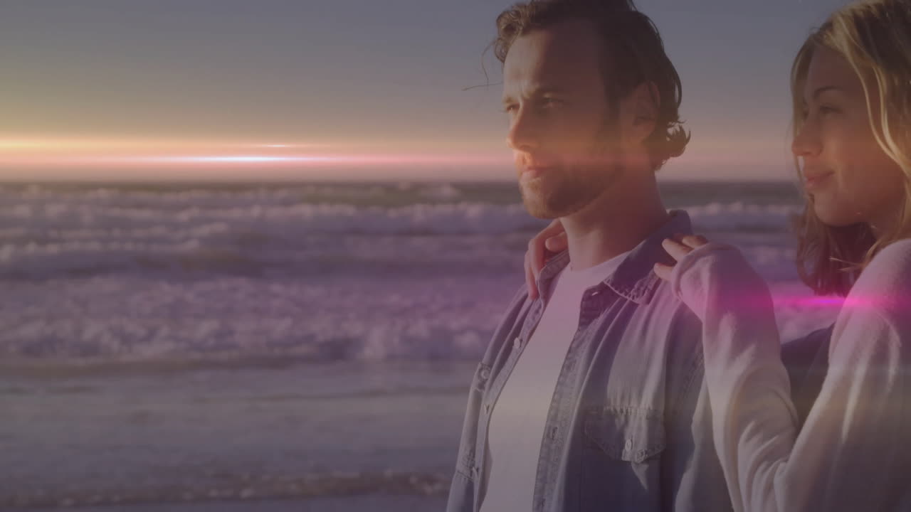 couple sharing sunset moment on beach, health app overlay showing beating heart icon