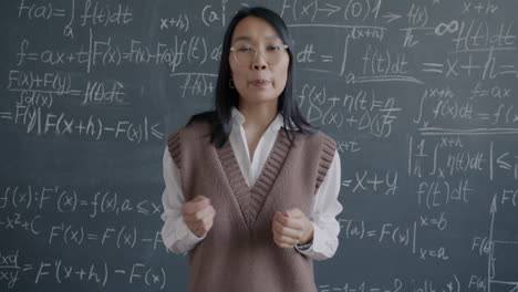 teacher explaining math concepts on a blackboard