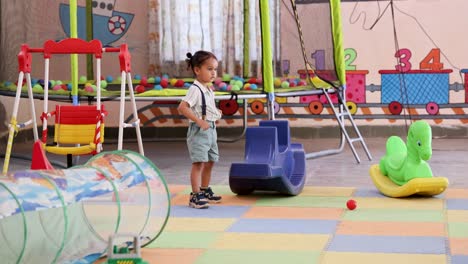 cute indian kid playing with toys at preschool indoor activity time