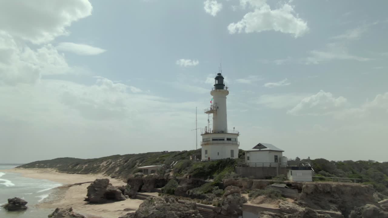 4K aerial rise-pan rocks to lighthouse