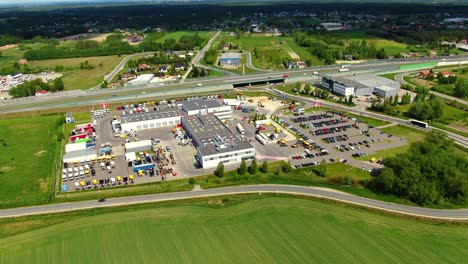 aerial top down view of the big logistics park with warehouses, loading hub and a lot of semi trucks with cargo trailers awaiting for loading unloading goods on ramps