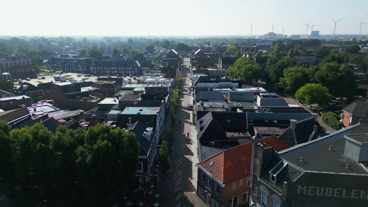Drone shot overlooking downtown Coevorden with rooftops, trees, and a visible public square under clear sky. Captured in Coevorden, Drenthe, Netherlands (Coevorden, Drenthe, Nederland)