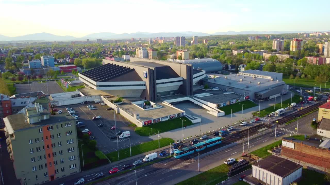 Aerial approach of the multifunctional Ostravar Arena, highlighting its modern architecture and spacious surroundings