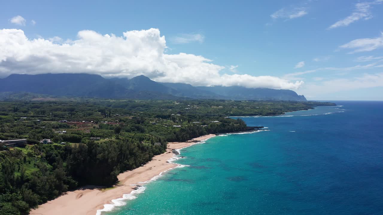 Super wide aerial shot flying over the beautiful northern coastline of Kaua'i at Princeville in Hawai'i