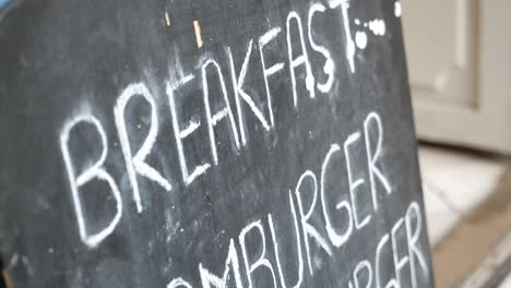 breakfast and burger menu on chalkboard sign