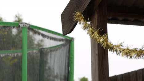 wet sad day with heavy rain falling on children's cubby house during christmas